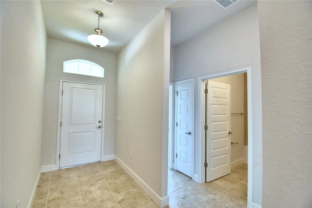 entryway with light tile patterned floors