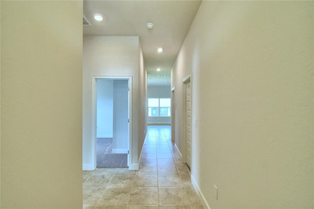 corridor with light tile patterned floors