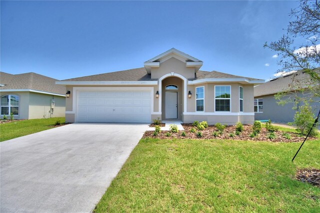 view of front of property with a garage and a front yard