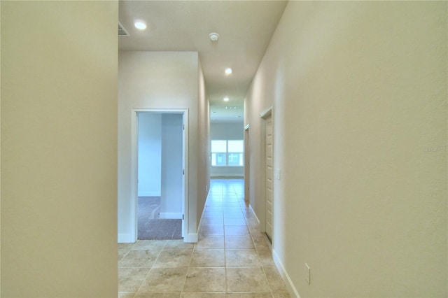 hall with light tile patterned floors