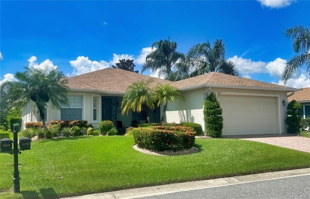 ranch-style house with a garage and a front yard