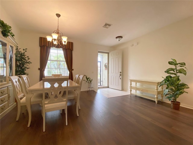 dining area with a notable chandelier and hardwood / wood-style floors