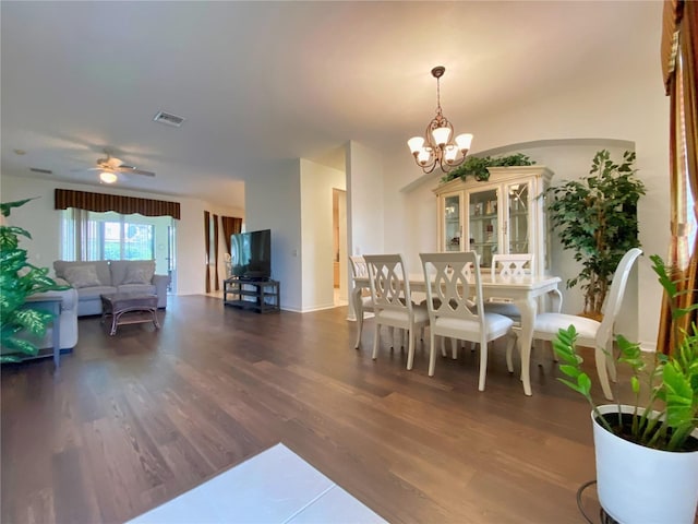 dining room featuring dark hardwood / wood-style floors and ceiling fan with notable chandelier