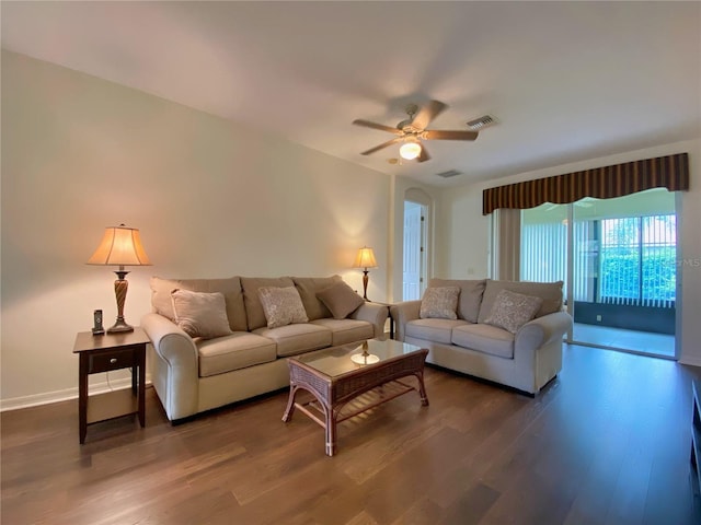 living room with ceiling fan and dark hardwood / wood-style flooring