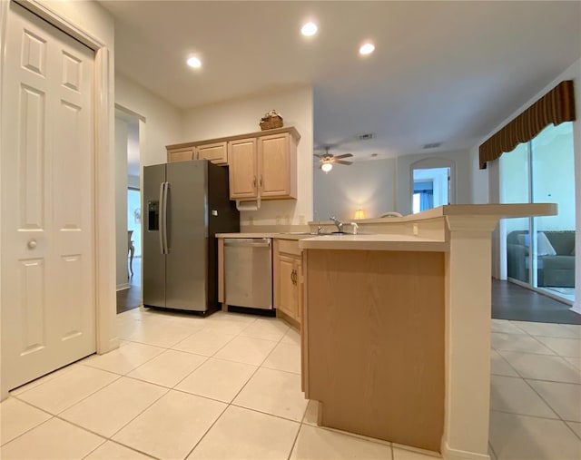 kitchen featuring light brown cabinetry, sink, kitchen peninsula, ceiling fan, and stainless steel appliances