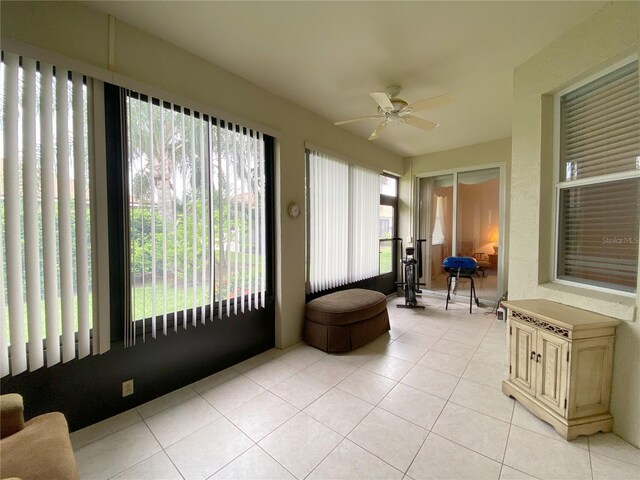 sunroom featuring ceiling fan