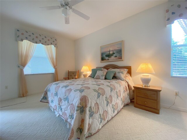 carpeted bedroom featuring ceiling fan and multiple windows