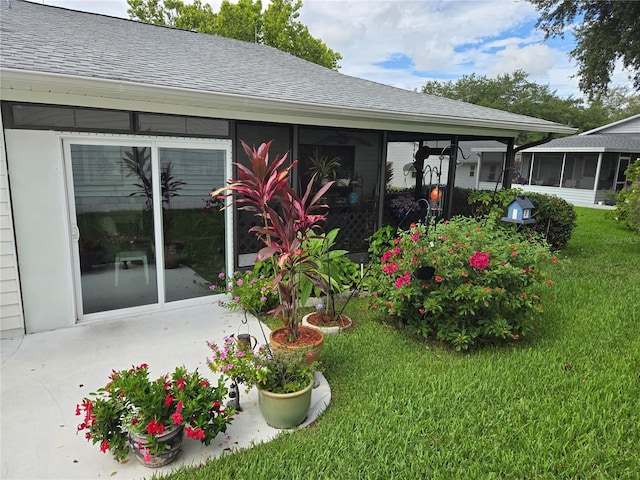 view of yard featuring a sunroom and a patio