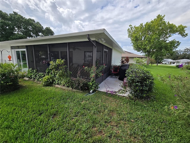 exterior space with a lawn and a sunroom