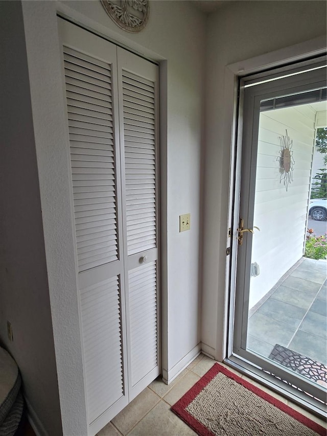 doorway featuring light tile patterned flooring