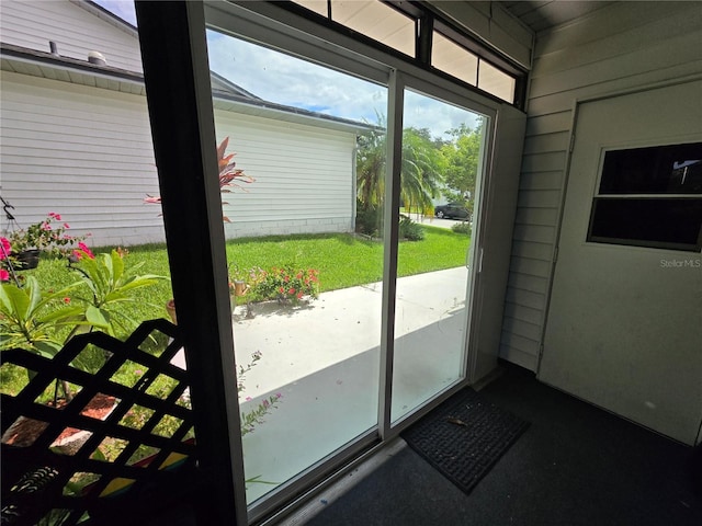 doorway to outside featuring wood walls