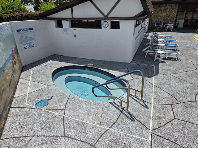 view of pool featuring a community hot tub and a patio area