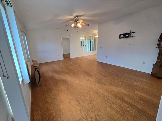 spare room featuring hardwood / wood-style flooring, vaulted ceiling, and ceiling fan