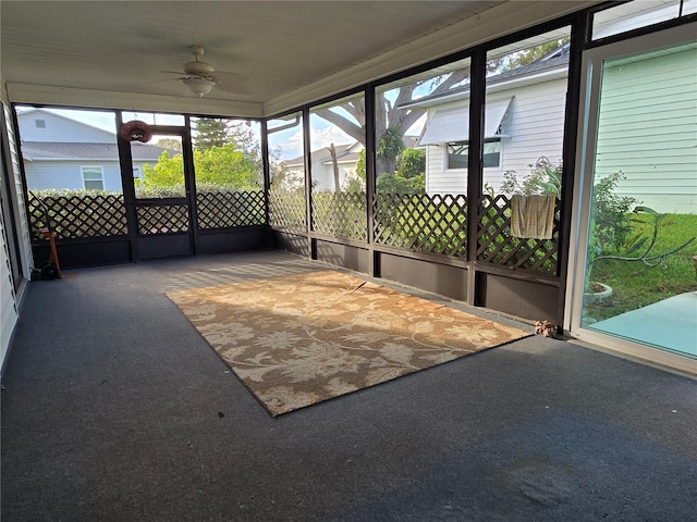 unfurnished sunroom featuring ceiling fan