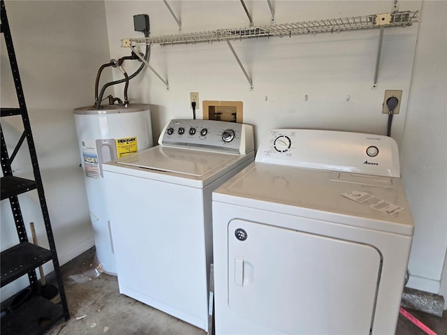 washroom with washing machine and clothes dryer and water heater