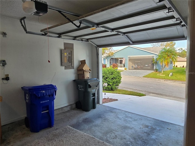 garage with a garage door opener and electric panel