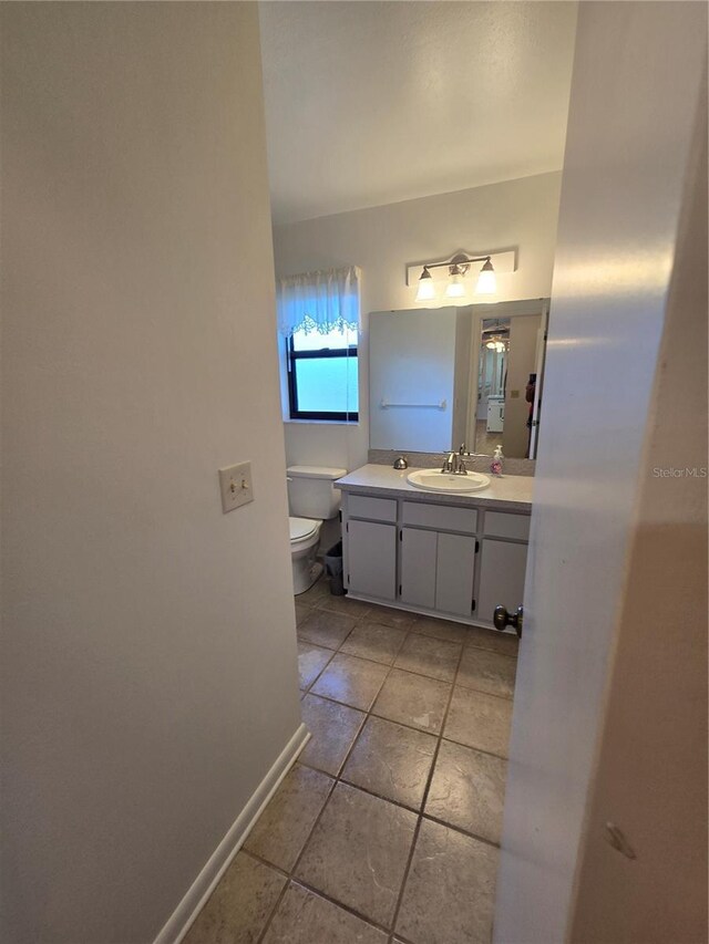 3130 Prairie Dunes Cir W, Lakeland, FL 33810 - bathroom with toilet, vanity, baseboards, and tile patterned floors