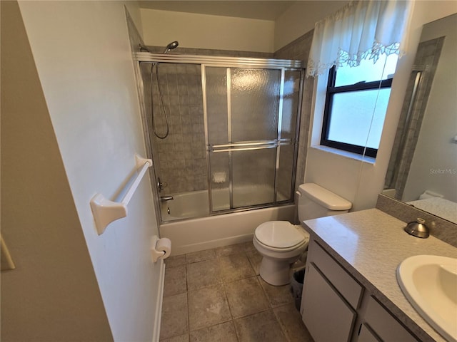 full bathroom featuring vanity, combined bath / shower with glass door, and toilet