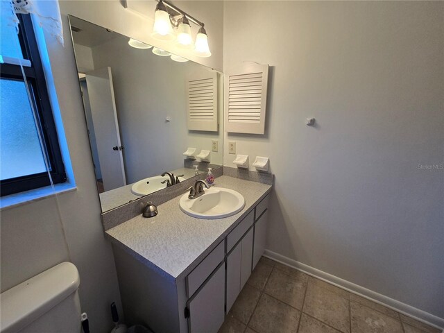 3130 Prairie Dunes Cir W, Lakeland, FL 33810 - bathroom with vanity, toilet, baseboards, and tile patterned flooring