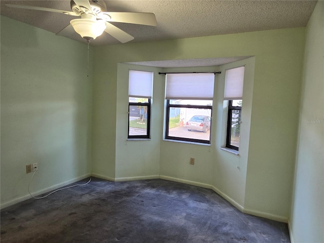 empty room featuring dark carpet and a textured ceiling