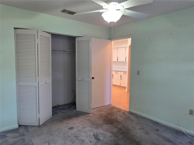 unfurnished bedroom featuring carpet flooring, ceiling fan, and a closet