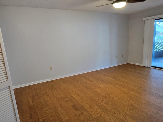 spare room featuring hardwood / wood-style floors and ceiling fan