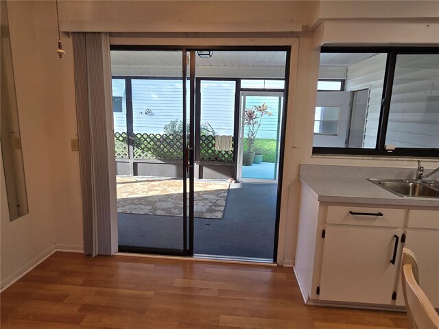 3130 Prairie Dunes Cir W, Lakeland, FL 33810 - doorway to outside with a sink, light wood finished floors, and baseboards