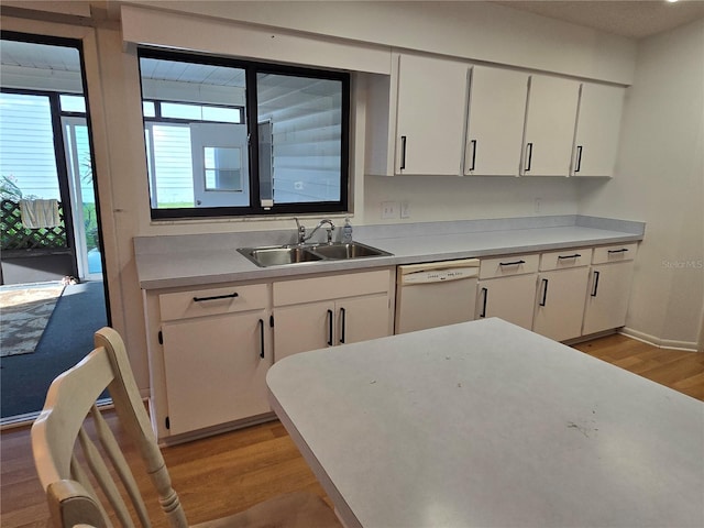 kitchen featuring dishwasher, sink, white cabinets, and light wood-type flooring