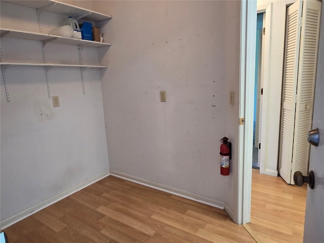 laundry area with light hardwood / wood-style flooring