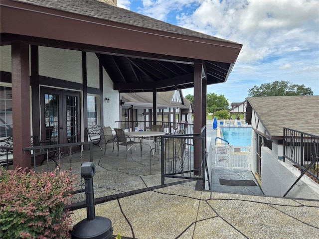 view of patio / terrace with a community pool and french doors