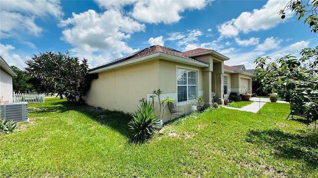 view of home's exterior featuring a lawn and cooling unit