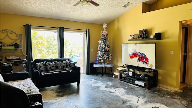 living room featuring ceiling fan, concrete flooring, and a textured ceiling