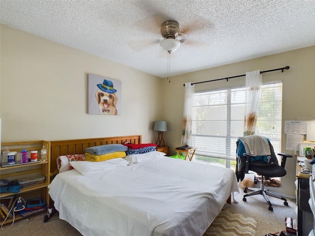 carpeted bedroom with multiple windows, a textured ceiling, and ceiling fan