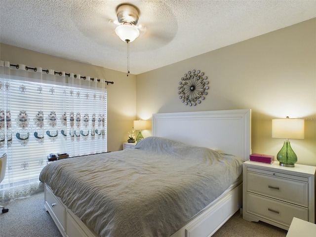 bedroom featuring light carpet, multiple windows, a textured ceiling, and ceiling fan