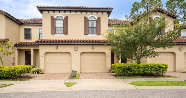 mediterranean / spanish-style home with a garage