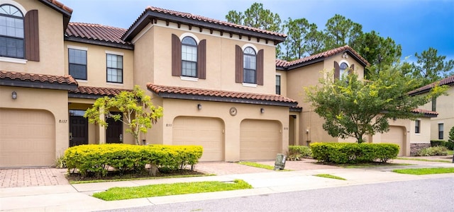 mediterranean / spanish-style home featuring a garage