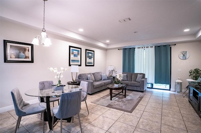 tiled living room featuring an inviting chandelier