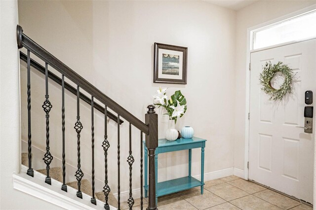 entryway with light tile patterned floors