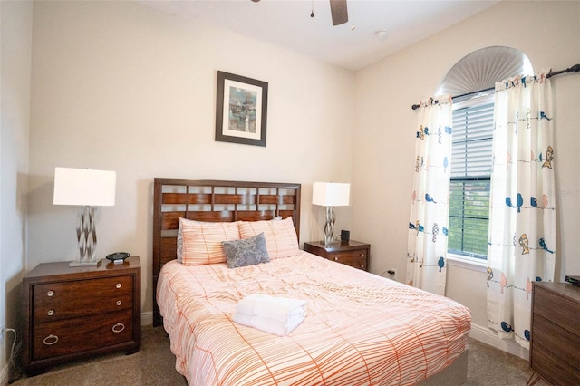 bedroom with dark colored carpet and ceiling fan