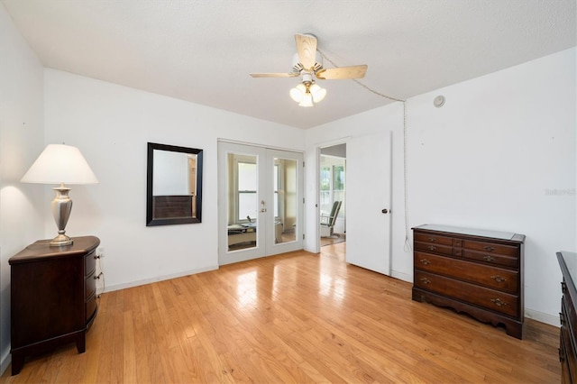 bedroom featuring ceiling fan, french doors, and light hardwood / wood-style flooring