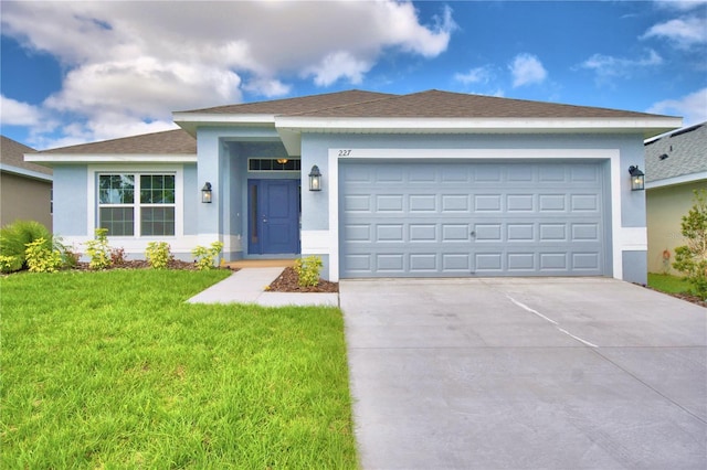 single story home with a garage and a front lawn