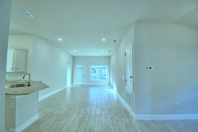 interior space with sink and vaulted ceiling