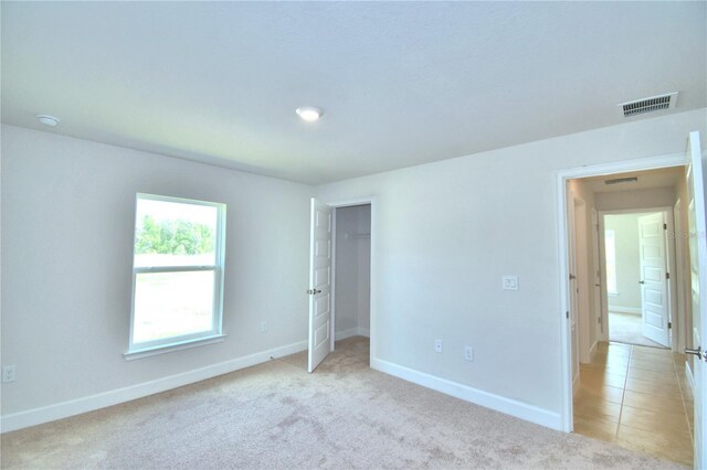 unfurnished bedroom featuring light colored carpet