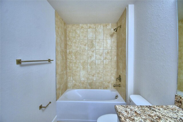 full bathroom with vanity, tiled shower / bath combo, and toilet