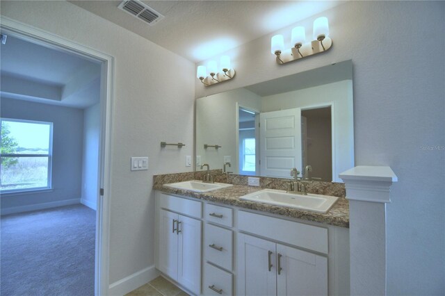 bathroom featuring double sink vanity and a textured ceiling