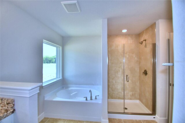 bathroom featuring plus walk in shower and tile patterned flooring