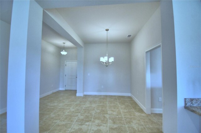 unfurnished dining area with tile patterned flooring and an inviting chandelier