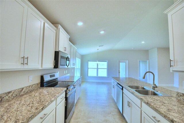 kitchen with stainless steel appliances, sink, lofted ceiling, light tile patterned flooring, and white cabinetry