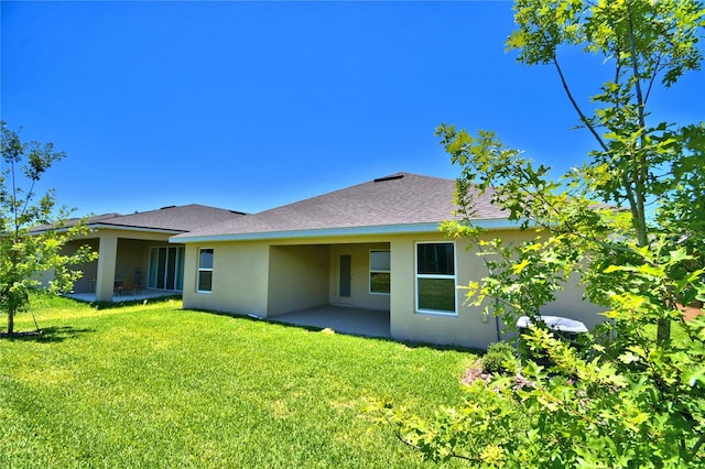 rear view of property with a patio area and a yard