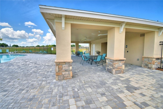 view of patio / terrace featuring ceiling fan and a community pool